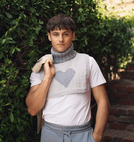 Young man wearing a grey dickie with a gray heart design