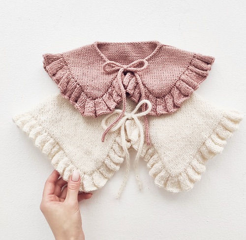 Two collars one pink and one white, both with ruffles and ties