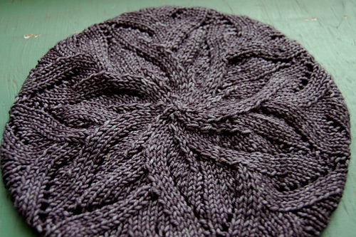 Close up of a knitted beret with star/flower pattern