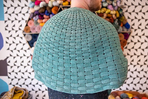 Person wearing a green basketweave texture shawl