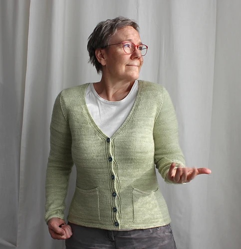 Person wearing a green knit cardigan