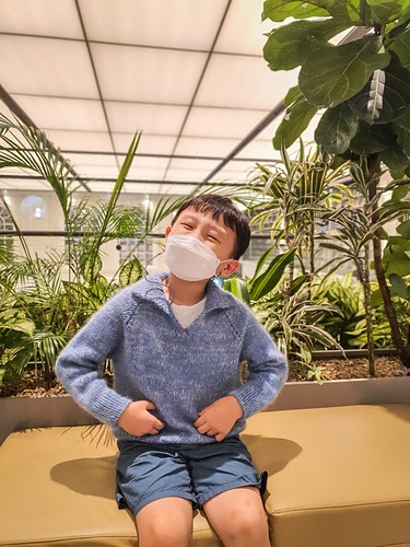 Child wearing a blue knit sweater with collar