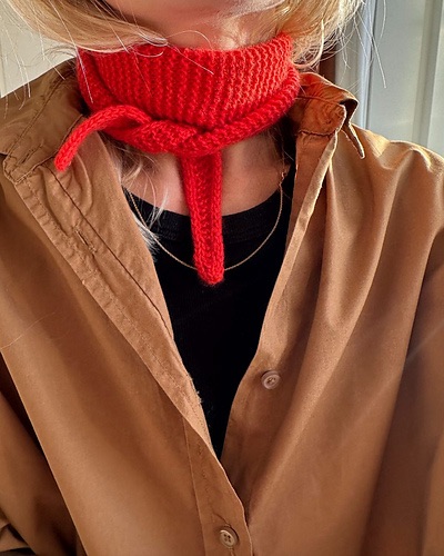 Person wearing a red knit scarf 