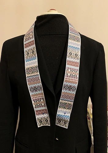Mannequin wearing a paper mock-up of a fair isle patterned scarf