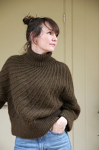 person wearing a brown knitted jumper