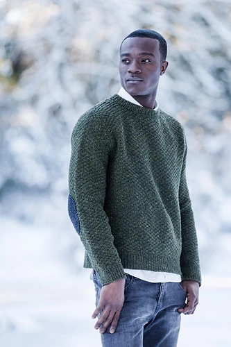 person wearing a green knit sweater